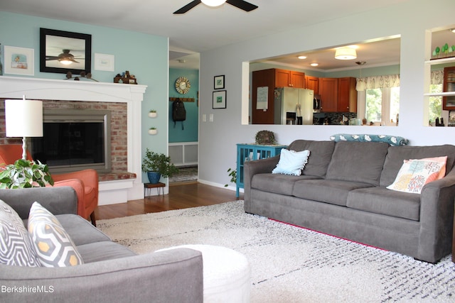 living room with ceiling fan and dark hardwood / wood-style floors