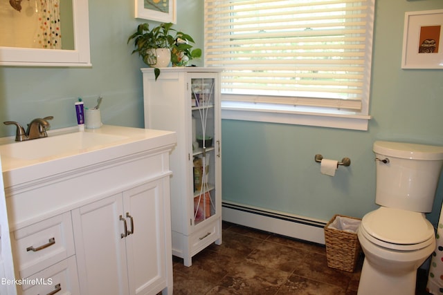 bathroom featuring vanity, toilet, and a baseboard radiator