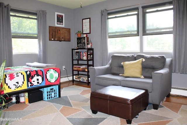 living room featuring a healthy amount of sunlight and a baseboard radiator