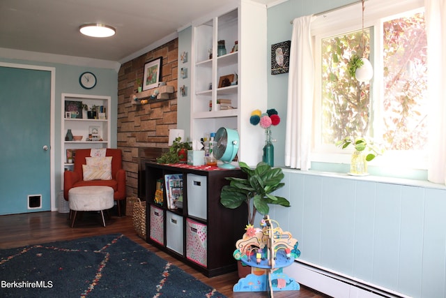 sitting room with dark hardwood / wood-style flooring and a baseboard heating unit