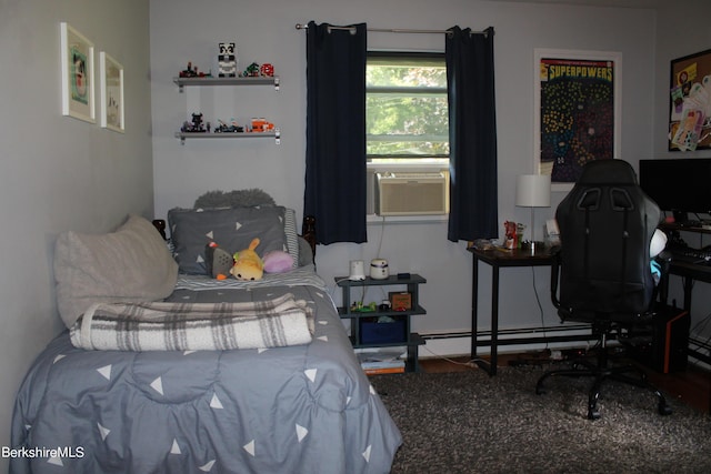 bedroom with baseboard heating and cooling unit