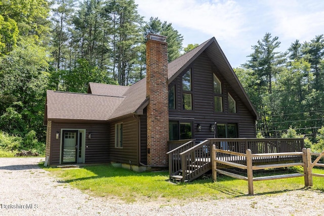 20 Hillside Ln, Sheffield, MA 01222 - view of front of house featuring a chimney, a deck, roof with shingles, and log veneer siding