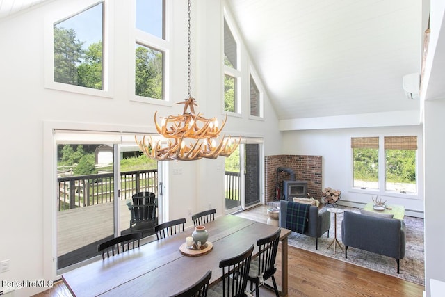20 Hillside Ln, Sheffield, MA 01222 - dining space featuring high vaulted ceiling, a chandelier, a baseboard heating unit, wood finished floors, and a wood stove