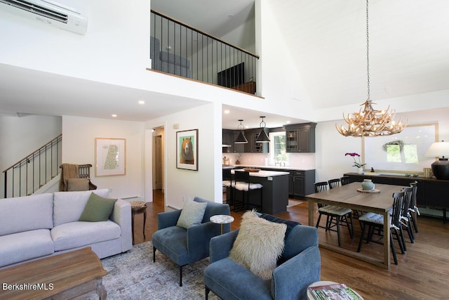 20 Hillside Ln, Sheffield, MA 01222 - living room featuring stairway, wood finished floors, a chandelier, a towering ceiling, and an AC wall unit