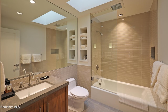 full bathroom featuring visible vents, built in shelves, toilet, a skylight, and bathtub / shower combination