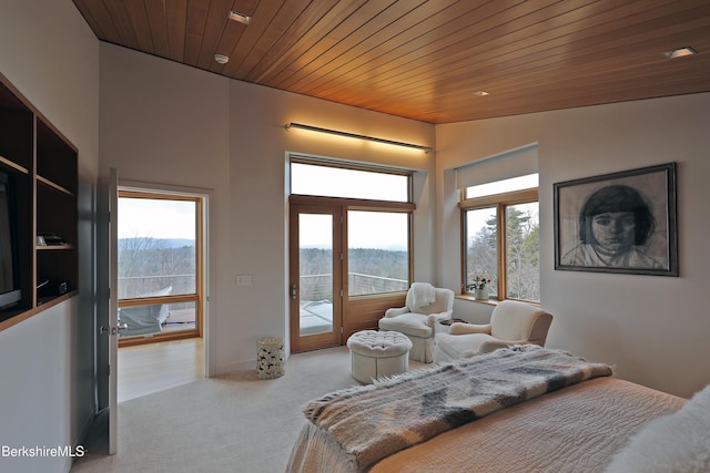 bedroom with access to exterior, multiple windows, wooden ceiling, and carpet