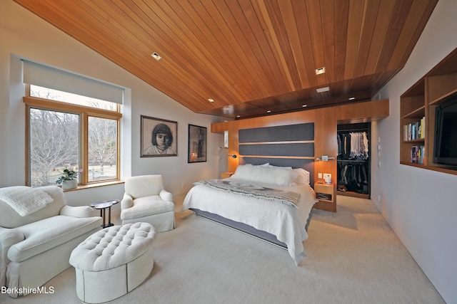 bedroom featuring a walk in closet, lofted ceiling, wooden ceiling, and carpet flooring