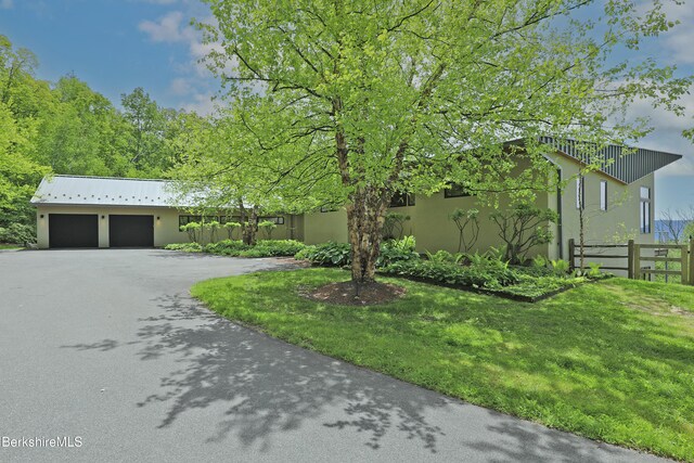 113 Brush Hill Rd, Great Barrington, MA 01230 - view of front of house featuring asphalt driveway, stucco siding, and a garage