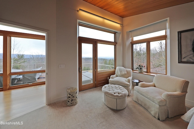 sitting room featuring a mountain view, visible vents, wooden ceiling, and baseboards