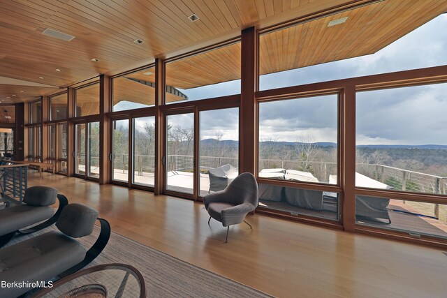 113 Brush Hill Rd, Great Barrington, MA 01230 - living room featuring expansive windows, plenty of natural light, a mountain view, wood finished floors, and wooden ceiling