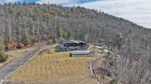 drone / aerial view featuring a view of trees