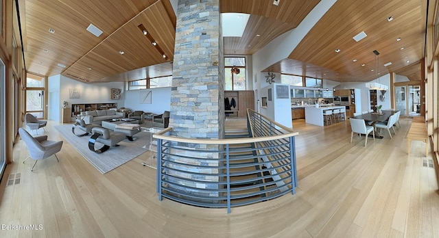 living room with visible vents, wood ceiling, decorative columns, light wood-style floors, and high vaulted ceiling