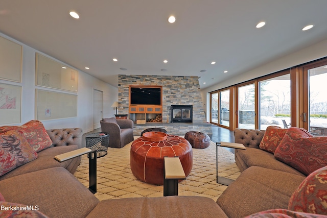 living area featuring recessed lighting and a fireplace