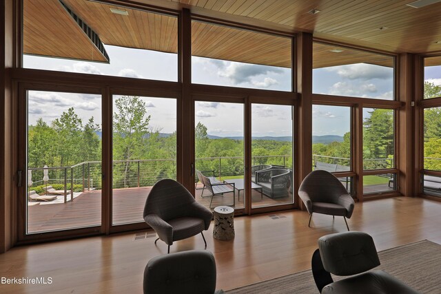 113 Brush Hill Rd, Great Barrington, MA 01230 - sunroom featuring wood ceiling, a wooded view, wood finished floors, and expansive windows