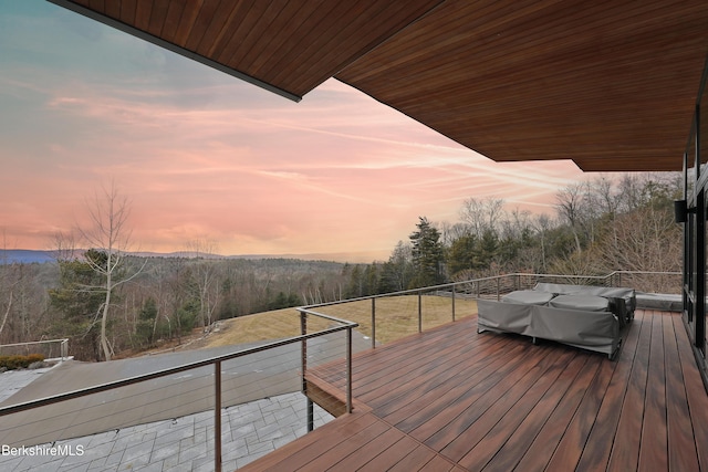 wooden deck with a view of trees