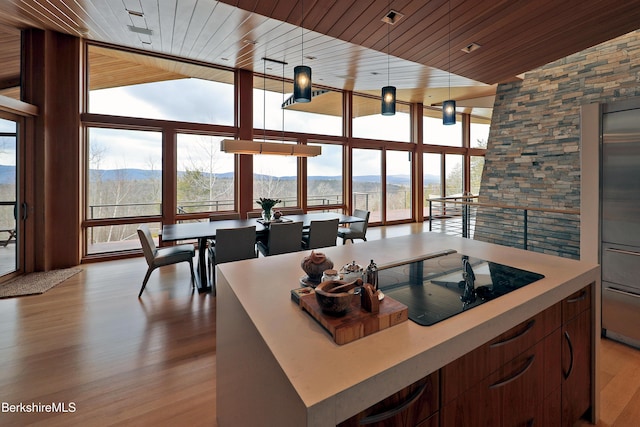 kitchen with wooden ceiling, floor to ceiling windows, and a mountain view