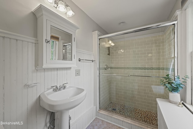 68 Colt Rd, Pittsfield, MA 01201 - bathroom featuring a stall shower, a wainscoted wall, and a sink