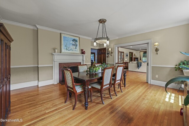 68 Colt Rd, Pittsfield, MA 01201 - dining space with light wood finished floors, a fireplace, ornamental molding, and baseboards