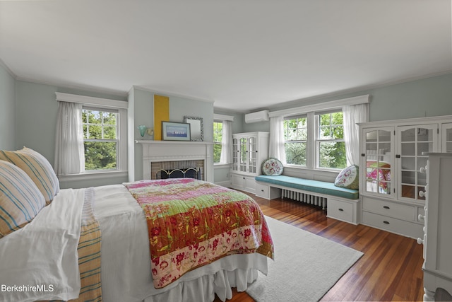 68 Colt Rd, Pittsfield, MA 01201 - bedroom with a wall mounted air conditioner, multiple windows, radiator heating unit, wood finished floors, and ornamental molding