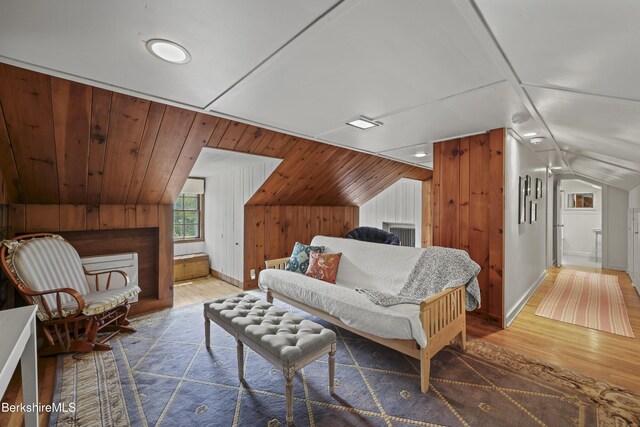 68 Colt Rd, Pittsfield, MA 01201 - bedroom featuring wood finished floors, vaulted ceiling, wood walls, and baseboards