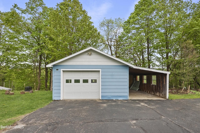 garage featuring a garage and asphalt driveway