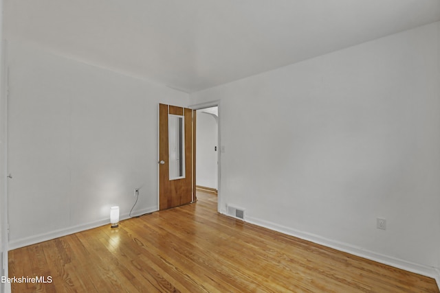 unfurnished room with wood finished floors and baseboards