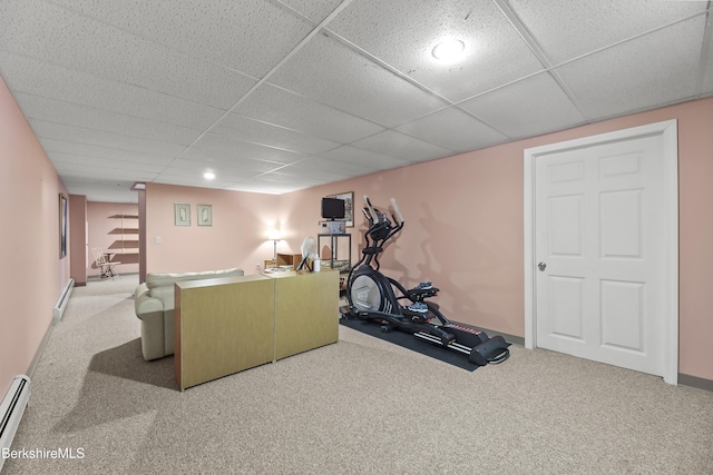 workout room with carpet floors, a baseboard radiator, and a paneled ceiling