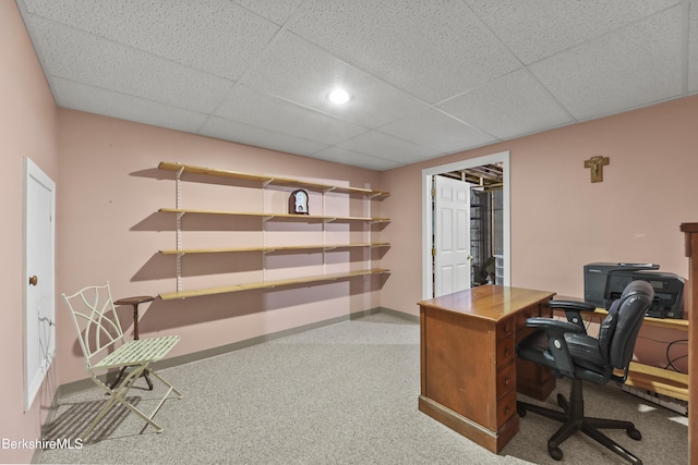 office featuring a drop ceiling and baseboards