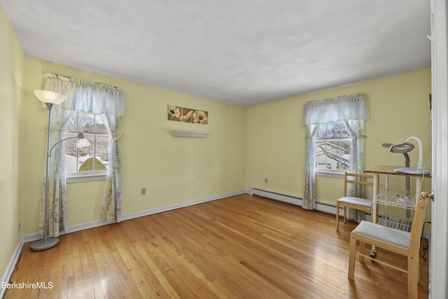 living area with hardwood / wood-style floors and baseboards