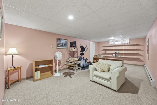 interior space featuring baseboards, baseboard heating, and a drop ceiling