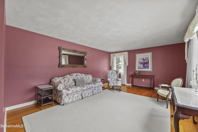 living room with baseboards and wood finished floors