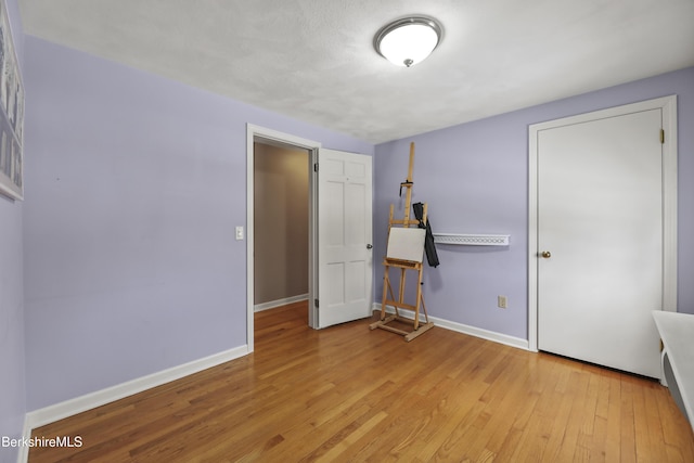 unfurnished bedroom featuring baseboards and light wood finished floors