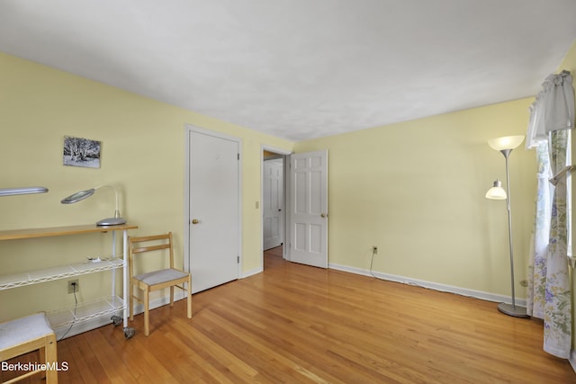 bedroom featuring wood finished floors and baseboards