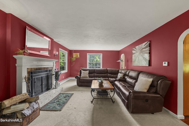 785 E New Lenox Rd, Pittsfield, MA 01201 - living room featuring arched walkways, carpet, and a brick fireplace