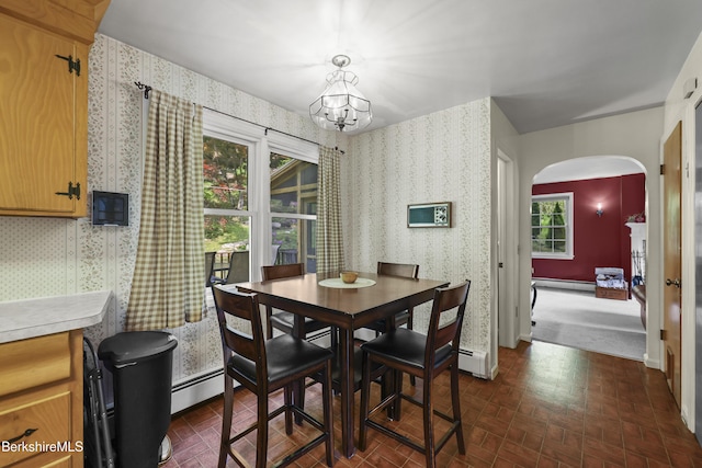 785 E New Lenox Rd, Pittsfield, MA 01201 - dining space with arched walkways, wallpapered walls, brick patterned flooring, a chandelier, and a baseboard radiator