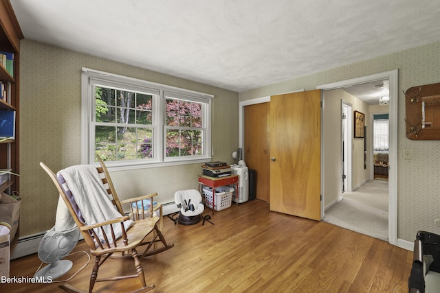 785 E New Lenox Rd, Pittsfield, MA 01201 - sitting room with wallpapered walls and light wood-style floors