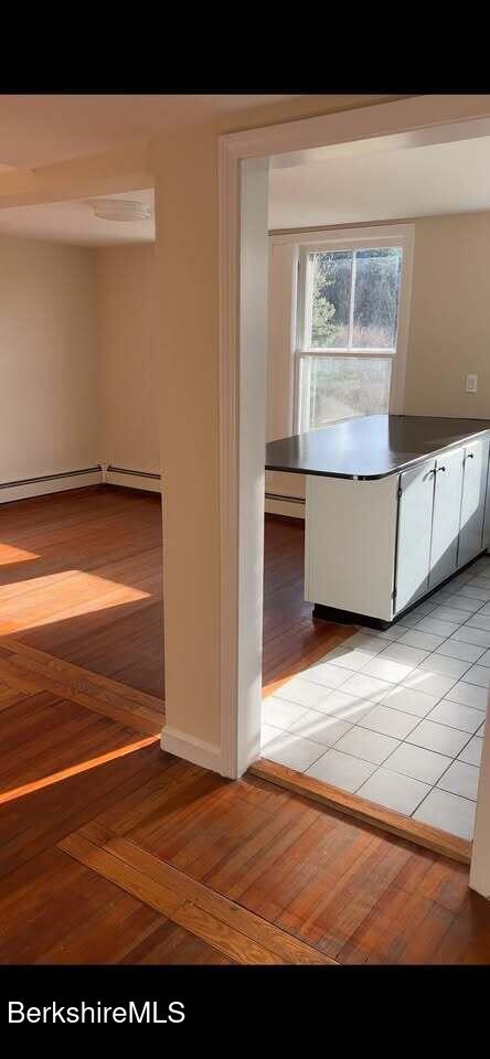 kitchen featuring baseboards and baseboard heating