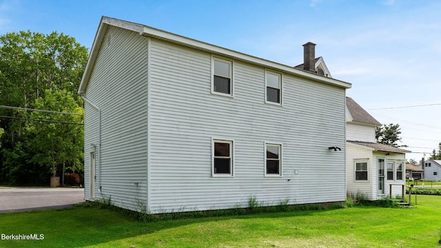 469 Pecks Rd, Pittsfield, MA 01201 - back of house featuring a chimney, a yard, and roof with shingles