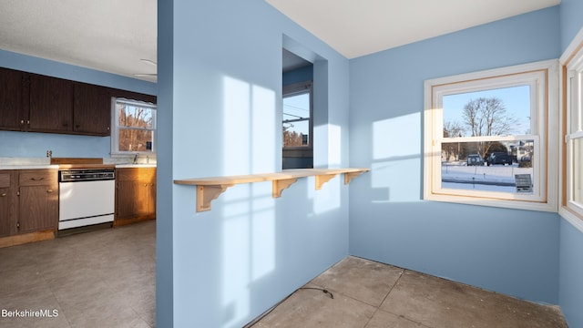 469 Pecks Rd, Pittsfield, MA 01201 - kitchen featuring dishwasher, light countertops, a sink, a kitchen breakfast bar, and concrete flooring