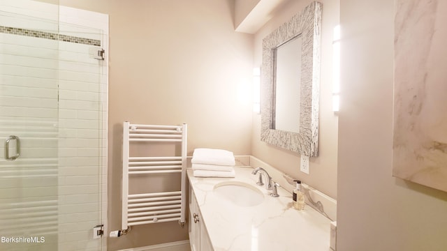 bathroom featuring radiator heating unit, vanity, and a shower stall