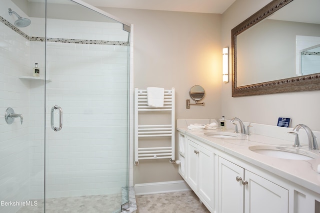 full bathroom with radiator, a shower stall, and a sink