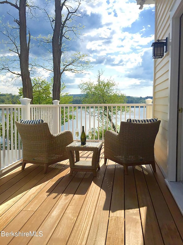 wooden terrace featuring a water view