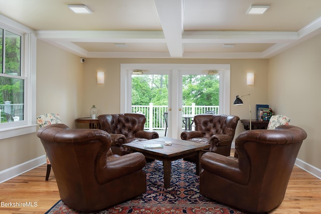 living room featuring light wood-type flooring, coffered ceiling, beamed ceiling, and baseboards