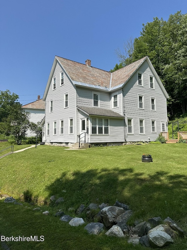 132-134 Crest St, North Adams, MA 01247 - back of property with a chimney, a lawn, and entry steps