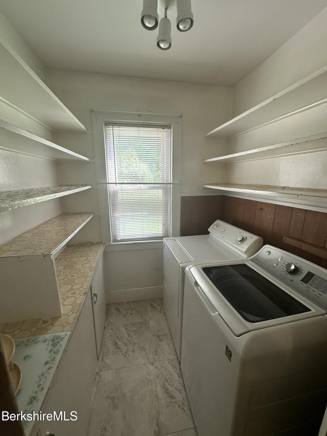 132-134 Crest St, North Adams, MA 01247 - laundry room featuring washing machine and dryer, cabinet space, and light marble finish flooring
