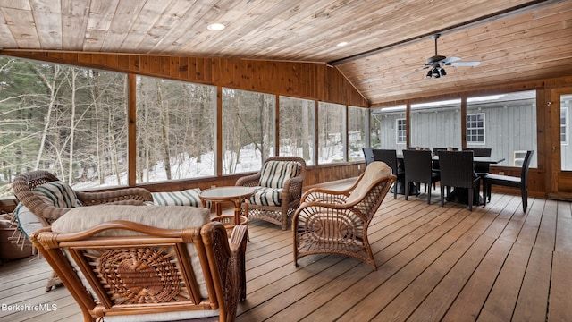 sunroom / solarium with lofted ceiling, a ceiling fan, and wooden ceiling