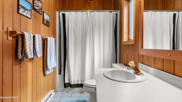 bathroom with tile patterned floors, toilet, a baseboard heating unit, wood walls, and vanity