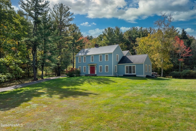 colonial home with a front lawn