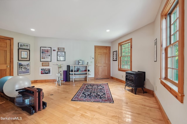 sitting room with light wood-type flooring and a wood stove