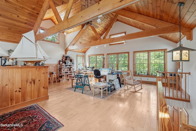 dining area featuring beamed ceiling, high vaulted ceiling, light hardwood / wood-style flooring, and wooden ceiling